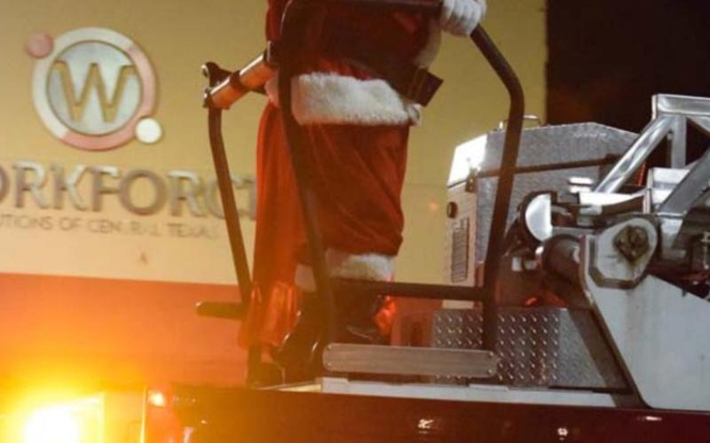 Santa and Mrs. Claus appear on a fire engine at the finale of the Holidazzle Parade. ALEXANDRIA RANDOLPH | DISPATCH RECORD