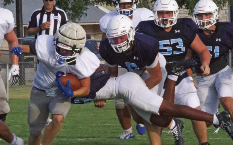 The Badgers look for an open lane on a rushing play against the Liberty Hlll Legacy Ranch Wranglers last Friday in the season’s first scrimmage. JEFF LOWE | COURTESY PHOTO
