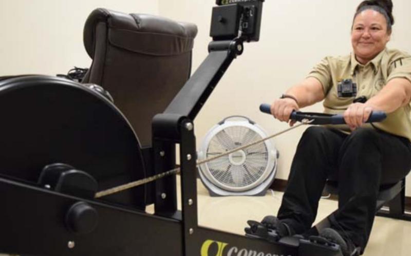 Lampasas County Sheriff’s Office Detention Sgt. Carmen Scarborough tries the Concept 2 rower for the first time. The rower is part of a new health and wellness pilot program brought to the sheriff’s office by the Texas Association of Counties. ALEXANDRIA RANDOLPH | DISPATCH RECORD