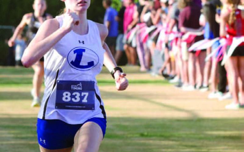 Kenzie Stone runs to the finish line during the Vista Ridge Invitational on Friday morning in Cedar Park. Stone was the second fastest Lady Badger runner on the day. ERICK MITCHELL | DISPATCH RECORD
