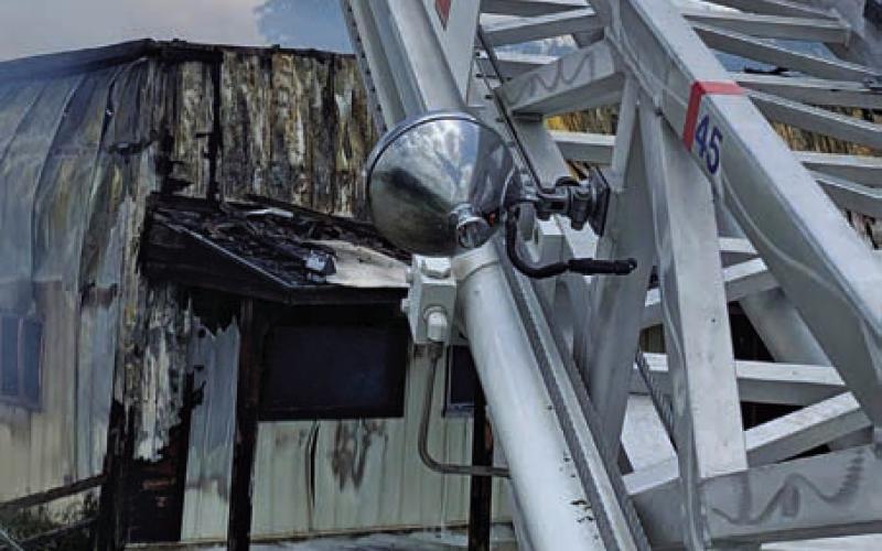 FILE PHOTO Lampasas Fire Department’s ladder truck, shown with its aerial ladder extended while Jared Payne fights a fire several years ago, has reached the end of its service life, according to national standards.