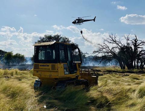 Wildfires arise unexpectedly, but having firebreaks on the land and a plan for cattle relocation are part of ranch preparedness when an emergency strikes. This photo shows a water drop during the Herring fire that occurred Aug. 11. Assistance from local emergency responders and the Texas Forest Service helped limit damage on the ranch. file photo