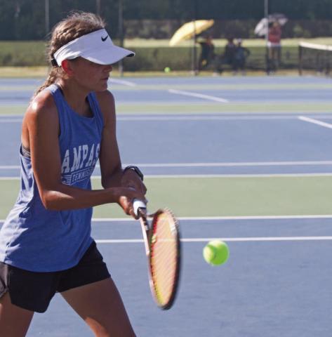 Madelynn White returns a ball on Tuesday in the tennis home opener. She won both her singles match and her doubles match with Tayler Sheard by the same score, 8-1. ERICK MITCHELL | DISPATCH RECORD