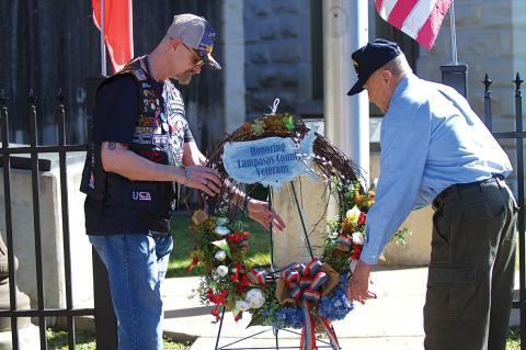 Sgt. Michael Uhler, at left, and former mayor and retired Col. Jack Calvert place a wreath at the Lampasas County Courthouse on Monday in honor of local veterans. Hunter King | dispatch record