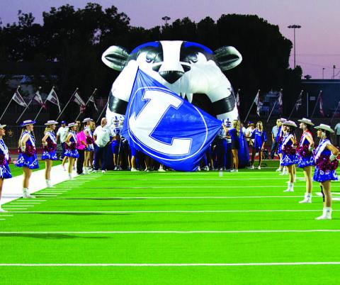 The Flames drill team welcomes the Badgers out of the tunnel every week. HUNTER KING | DISPATCH RECORD