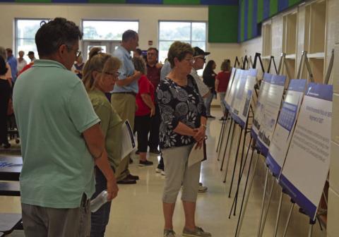 Lampasas County residents take a look at poster boards depicting plans for the Texas Department of Transportation’s U.S. Highway 190 project at Big Divide Road. ERICK MITCHELL | DISPATCH RECORD
