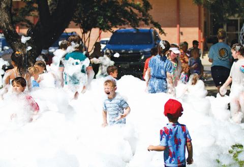 hunter king | Lampasas Dispatch Record A group of kids enjoys playing in the foam on Friday morning. Lampasas Public Library held its annual Foam Party on the library grounds.