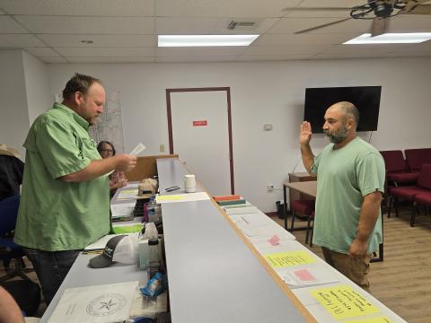 Lometa Mayor Derek Talley, left, administers the oath to council member Alex Witherspoon who will serve as mayor pro tem, while newly appointed council member Christine Eltgroth looks on during Monday night’s meeting.