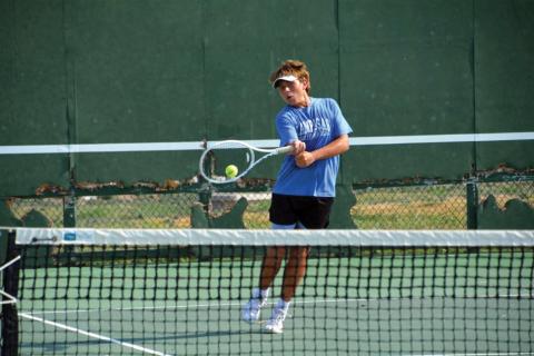 Dylan Skarzynski levels a volley back to his opponent in Tuesday’s singles match versus Weiss. COURTESY PHOTO
