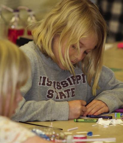 Hadley Crawford is busy preparing her strips of “protein” that will make a model of a double-helix DNA strand. The library hosted a STEAM event on “Heart and Lungs: Working Together.” JOYCESARAH MCCABE | DISPATCH RECORD
