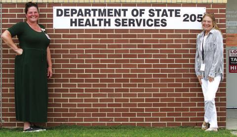 From left, Department of State Health Services staff at the Lampasas clinic, nurse Dee Edwards and specialist Tammy Pastor, pose for a photo outside the building located at 205 Water Street. ERICK MITCHELL | DISPATCH RECORD