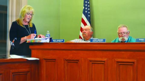 ERICK MITCHELL | DISPATCH RECORD County Auditor Tragina Tallant presents expense and revenue numbers to the Lampasas County Commissioners Court before adoption of the 2024-2025 budget and tax rate. Also pictured are Precinct 4 Commisioner Mark Ranwater, in center, and Precinct 3 Commissioner Lewis Bridges.