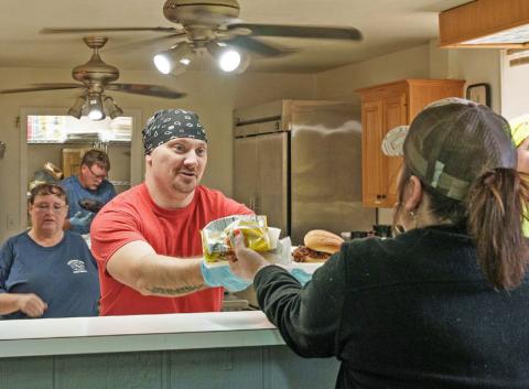 Adam barrios | DISPATCH RECORD Kempner Volunteer Fire Department member Steve Martin serves a lunch plate during the department’s annual BBQ Fundraiser and Auction on Saturday.