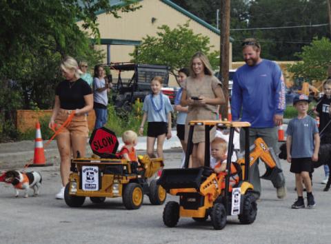 Spring Ho Pet Parade participants costumed as a Texas Department of Transporation Work crew enjoy the stroll down Live Oak Street. ERICK MITCHELL | DISPATCH RECORD