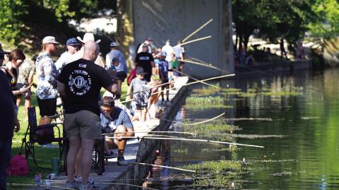 Poles lined the creek in W.M. Brook Park for the fishing derby. HUNTER KING | DISPATCH RECORD