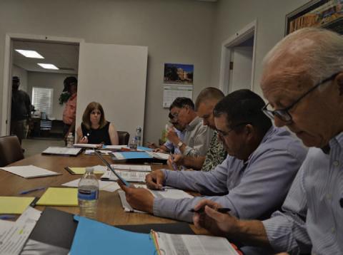 At back, Lampasas Central Appraisal District Chief Appraiser Susan Jones discusses budget matters Thursday evening alongside LCAD Board of Directors members. ERICK MITCHELL | DISPATCH RECORD