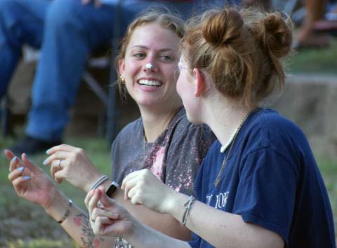 Lydia Skiles and Lyla Skiles snap along to the music at the annual Spring Ho Festival Gospel Night. JOSEPH NEUENSCHWANDER | LAMPASAS