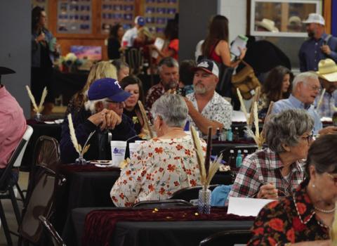 Reverse Raffle attendees enjoy a ribeye steak dinner during last year’s event. A similar meal will be served at this year’s showcase before the live auction gets underway. FILE PHOTO