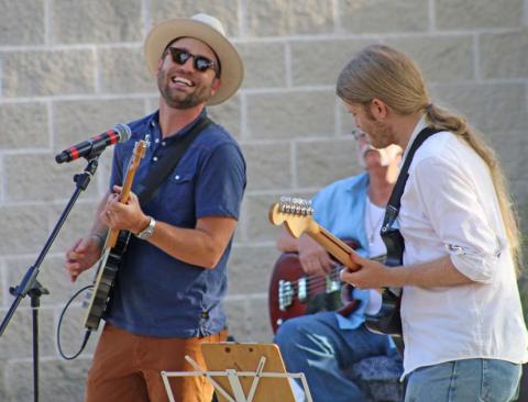 Cord Jackson, at right, performs a solo number while Zach Huckabee accompanies on guitar during the Tuesday night Hayloft Party. mason hines | dispatch record