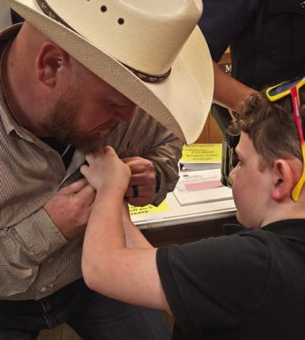 Lometa High School alum C.J. Faubion has his Lometa Police badge pinned by his son, Mavrick. Faubion is one of three new officers named to the force. CHERI JAY-WIENECKE | DISPATCH RECORD