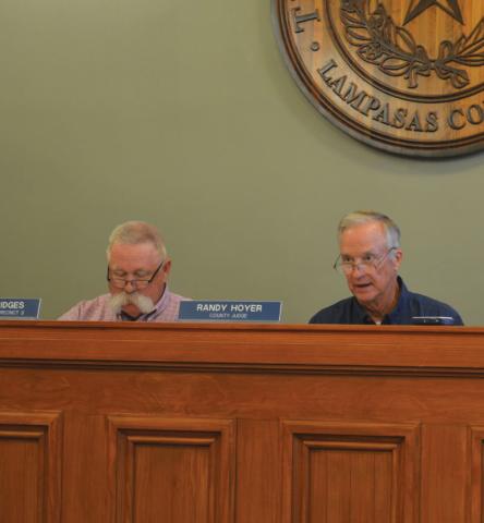 At left, Precinct 3 Commissioner Lewis Bridges looks on as County Judge Randy Hoyer speaks during the court’s regular meeting Aug. 12. erick mitchell | dispatch dispatch