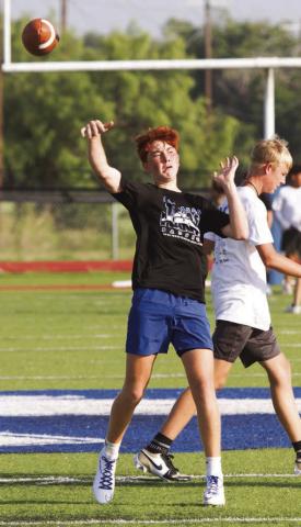 Incoming freshman Kaiser Morua launches a pass on Monday morning during a three-day camp held at Lampasas High School. ERICK MITCHELL | DISPATCH RECORD