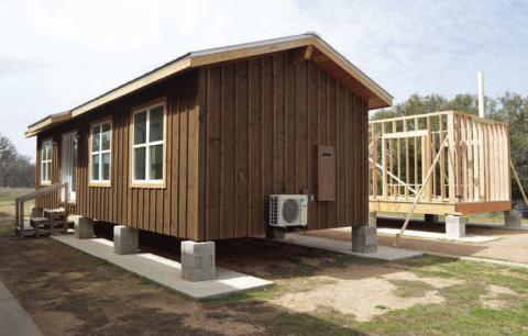 ERICK MITCHELL | DISPATCH RECORD Students in the high school’s construction program have worked with Creating Badger Builders mentors to complete a 560-square-foot tiny home. A second tiny home project, shown at back right, is in the intial construction stages.