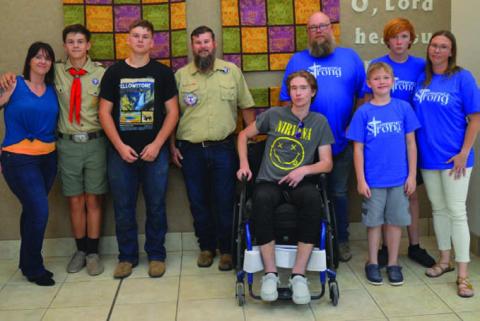 Trent Royar, second from left, has earned the Boy Scouts of America Heroism Award. He is joined by his parents, Cassie and Paul, along with brother Ethan. The Royar family is pictured with the Sappenfields -- from left to right, Hunter, Chad, Luke, Wyatt and Brandie Sappenfield. ERICK MITCHELL | DISPATCH RECORD