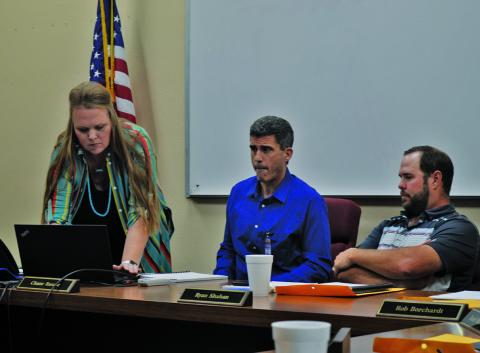 Liz Haviland, director of the Lampasas ISD’s Career and Technical Education program, works at her laptop to start a PowerPoint presentation for the school board meeting on Monday. Next to her are Superintendent Dr. Chane Rascoe, center, and Ryan Shahan, president of the LISD Board of Trustees. Enrollment in CTE classes continues to grow, Haviland said. ERICK MITCHELL | DISPATCH RECORD