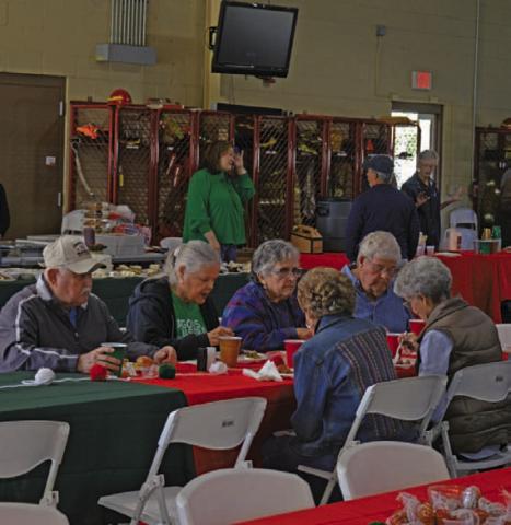 Lampasas County residents enjoy their meal during the Lampasas Volunteer Fire Department’s holiday lunch and toy drive on Monday. ERICK MITCHELL |DISPATCH RECORD
