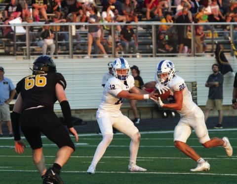 Ross Kothmann makes a handoff to John Stenson against Gatesville. ANA SOFIA MEYER | DISPATCH RECORD