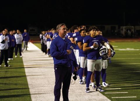Troy Rogers and his team stand for the National Anthem prior to the playoff game. HUNTER KING | DISPATCH RECORD