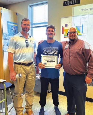 COURTESY PHOTO Lampasas High School selected Jonathan Vanliew, center, as its Teacher of the Month for August. Vanliew teaches biology and chemistry, as well as coaches. On hand to recognize him are Clay Phillips from Texas Farm Bureau Insurance, at left, and Assistant Principal Ryan Race.