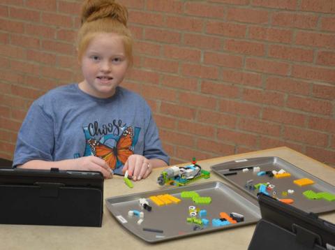 MONIQUE BRAND | DISPATCH RECORD Lauren Martin builds her robot project. Each student has use of a computer tablet with instructions and a controller. The library’s robotics initiative has grown since the program started in 2017. Sessions are offered for homeschool and public school students.