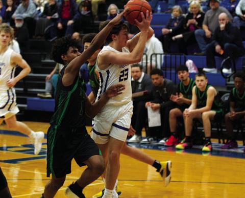 Ty Borchardt fights through contact from a Taylor defender to pass to a teammate. HUNTER KING | DISPATCH RECORD