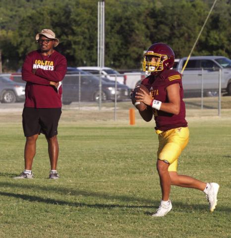 Lometa’s Jose Carbajal rolls out of the pocket as head coach Terrence Wadley observes during Thursday’s home scrimmage against Menard and May. ERICK MITCHELL | DISPATCH RECORD