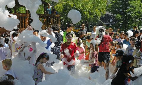 Children partied under a blanket of foam during the Lampasas Public Library’s Summer Reading program launch party on Friday. ERICK MITCHELL | DISPATCH RECORD