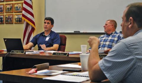 Lampasas Independent School District Superintendent Chane Rascoe, left, and Board of Trustees President Randy Morris discuss LISD state assessment scores during Monday’s meeting. At right is trustee Sam Walker. ERICK MITCHELL | DISPATCH RECORD