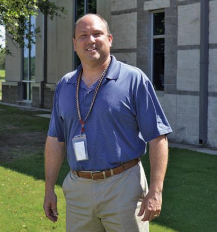 Paul Weinheimer stands outside Lampasas High School, where he has gone from teacher and football coach to assistant principal to now principal at the campus. ERICK MITCHELL | DISPATCH RECORD