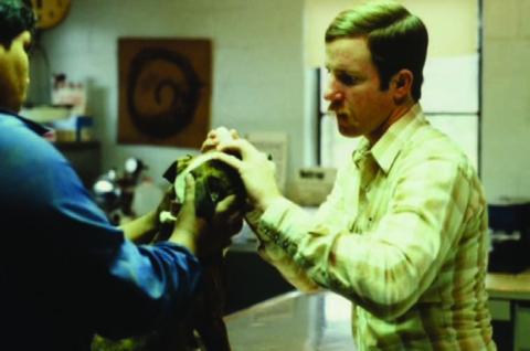A young Scott Rushing examines a dog at his veterinary clinic. COURTESY PHOTO