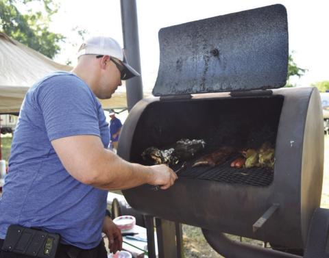 An LTX BBQ Fest cook-off contestant loads his smoker full of meats at a previous edition of the event. As that event has faded, Michael Olson, a former organizer of the LTX BBQ Fest and Creating Badger Builders member, has launched a new competition. The “Hotter than Hell 2.0” Barbecue Cookoff hosted by the local nonprofit plans to raise money for trade school scholarships through the contest. FILE PHOTO