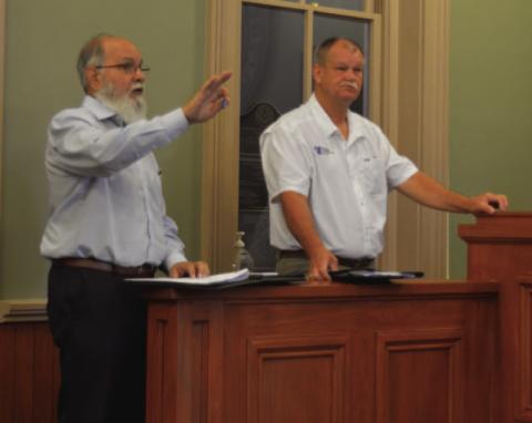 At left, Komatsu Architecture Design Coordinator Rick Stacy and Premier Construction’s Lee Evans discuss potential renovations to the county courthouse. Their comments came during Monday’s Lampasas County Commissioners Court meeting. ERICK MITCHELL | DISPATCH RECORD
