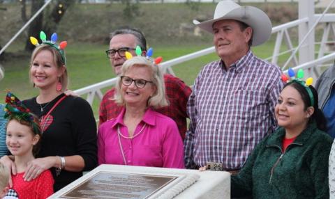 Friends and loved ones of the late Katherine Mezger gather at the newly erected bronze and stone memorial in W.M. Brook Park to celebrate her dedication to the Christmas on the Creek event. The event has grown every year in terms of displays offered and Lampasans who celebrate the Christmas season at the park with its festive lighting. Mezger was a driving force behind bringing the celebration to the community for all to enjoy. joycesarah mccabe | dispatch record