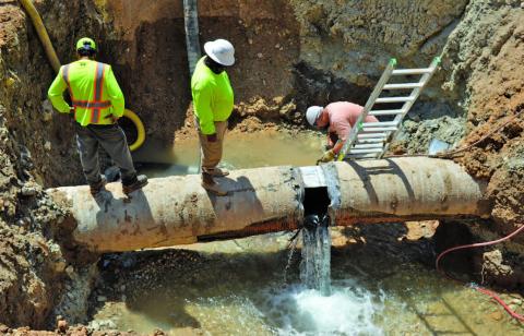 Workers empty the Kempner Water Supply Corp.’s main transmission line to Lampasas in July after a major leak occurred. ERICK MITCHELL | DISPATCH RECORD