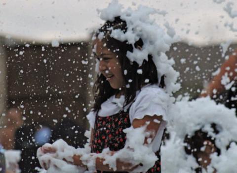 Lilianna Trevino is mesmerized by the falling “snow” she and her family enjoyed last Saturday at the annual Christmas on the Creek event. DAVID LOWE | DISPATCH RECORD