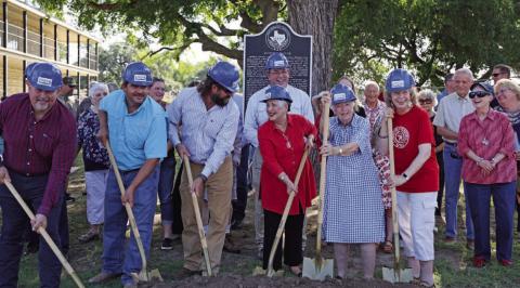 Community members gather to celebrate the upcoming construction work on the Hostess House. Work is set to begin July 1. Pictured in hard hats from left to right are City Council members Davis Keele, Eric Hernandez and Charlie Pratus; Mayor Herb Pearce; Lampasas County Historical Commission representative Clydell Wallce; Carol Northington Wright; and Diane Davis. JOYCESARAH MCCABE | DISPATCH RECORD