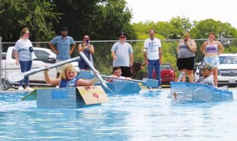At left, Sarah Wertz takes the lead in the race during Saturday’s Spring Ho Cardboard Regatta. CHLOE COWDREY | DISPATCH RECORD