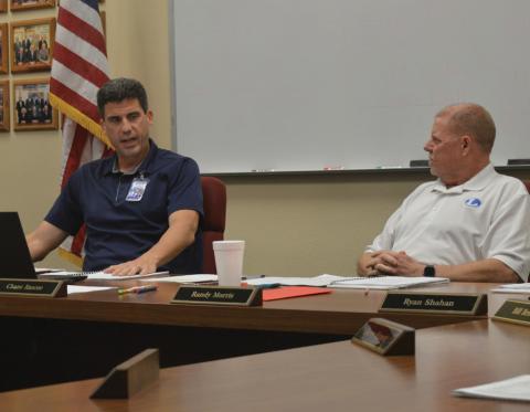 At left, LISD Superintendent Dr. Chane Rascoe discusses education matters with Board of Trustees President Randy Morris during Monday’s meeting. erick mitchell | dispatch record