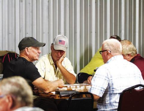 A group of meen sit down to start their game during the 42 tournament on the Tuesday of Spring Ho. There were likely around 40 teams that played in the competition. HUNTER KING | DISPATCH RECORD
