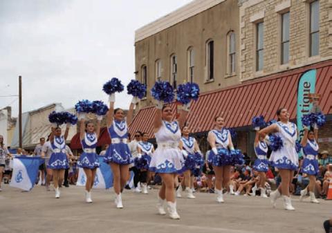 Lampasas cheerleaders dazzle spectators along Third Street during the Spring Ho Parade. ADAM BARRIOS | DISPATCH RECORD